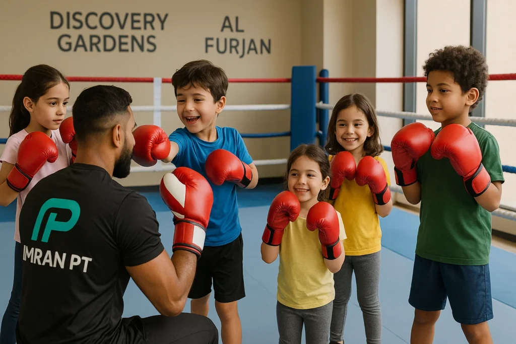 Kids boxing lessons in Discovery Gardens near Al Furjan with boxing coach wearing imran pt logo